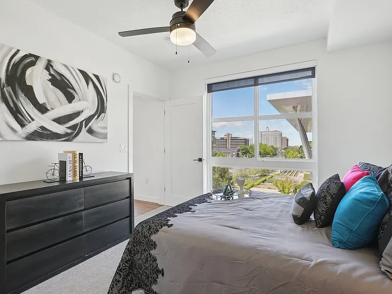 Liberty Duet Apartments, Salt Lake City, Utah; A bedroom with a large bed and a ceiling fan.