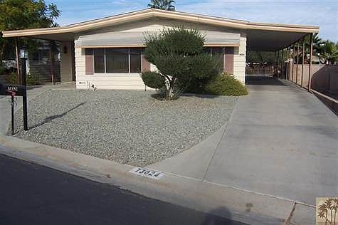 Front of home...driveway at right to the 2 car garage in ba