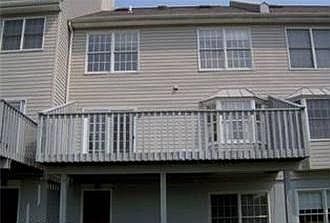 View of back of home and walk out basement