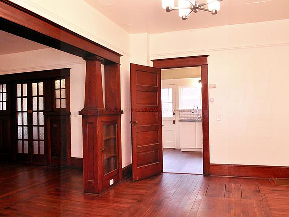Living and dining rooms with original floors and woodwork
