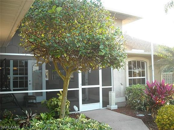 Tropical plantings and screened entry greet you...