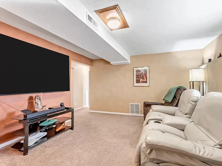 basement theater room with game closet and mounted tv (included in rental)