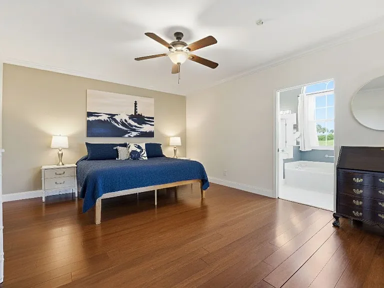 Primary bedroom with king bed, en suite, and large walk-in closet