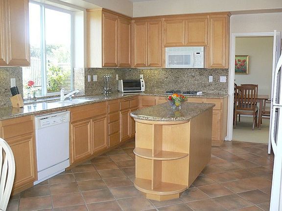 Diagonal tiled kitchen floors and slab granite counters!