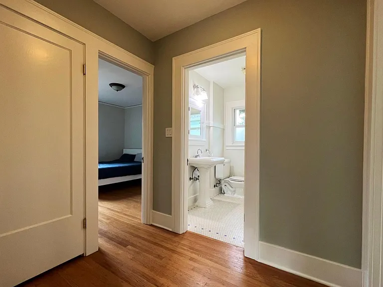 hallway between main floor bedrooms and classic craftsman bathroom