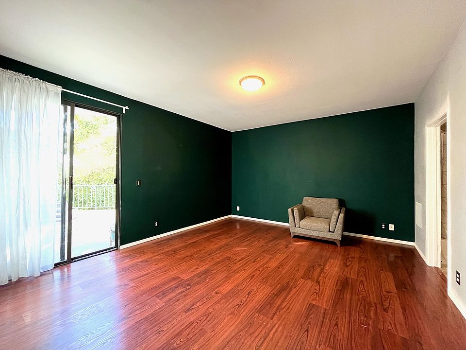 Primary bedroom with private bath, walk-in closet, and terrace access.
