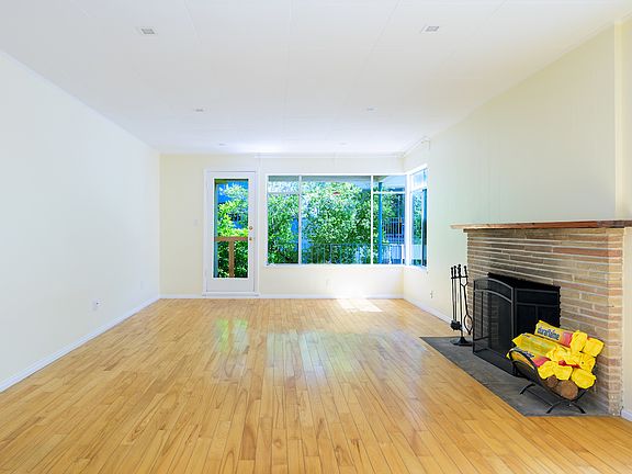 living room with fireplace and balcony