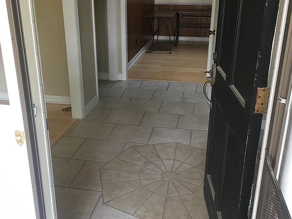 Tiled entry way with living room to the left, formal ding ro