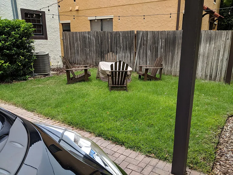 Backyard lawn space with firepit. Pre-plumbed for gas grill.