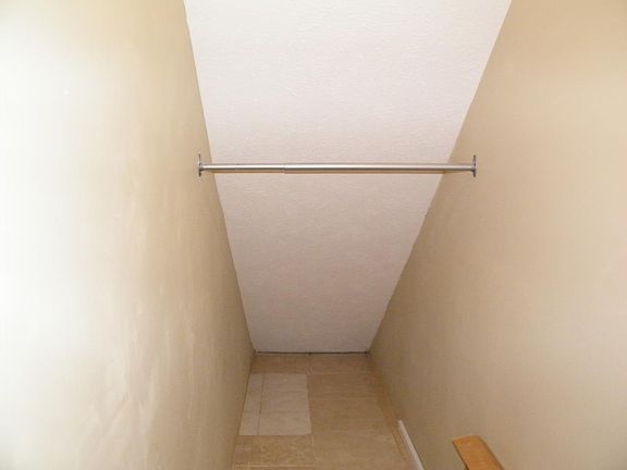 closet under stairs/living rm.