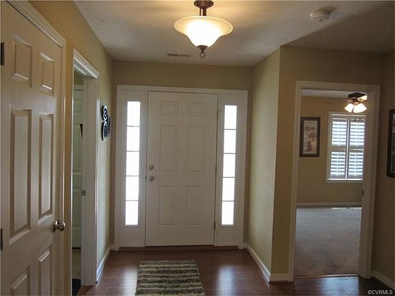 Foyer with wood floors and 2 closets