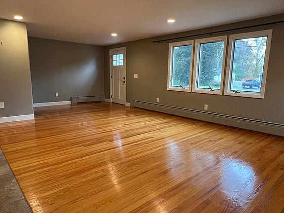 The front door leads to a large living room with hardwood floors and casement windows, easy to open to let in the breezes.