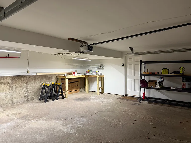 2 car garage with workbench and storage