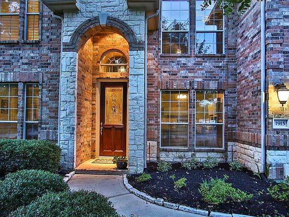 Great stone accents and deep covered entryway add to curb appeal.