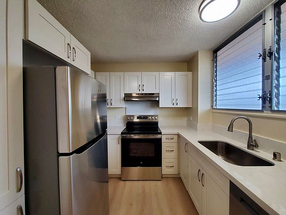 Fully renovated kitchen with new: cabinets, quart countertops, lighting, stainless steel range oven, stainless steel refrigerator, and more