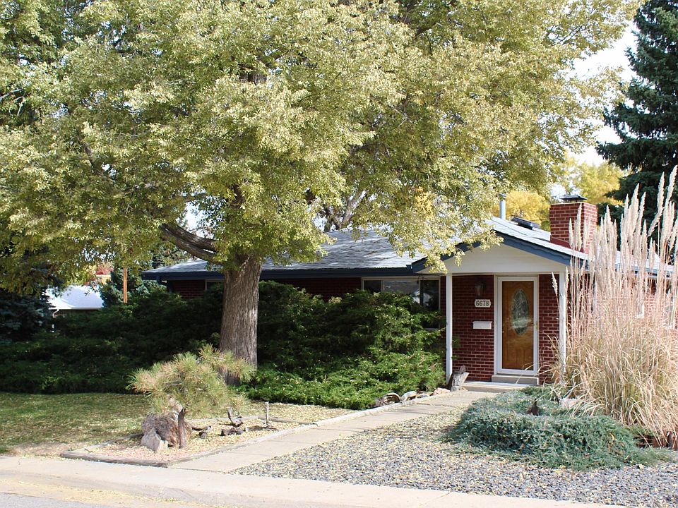 Front of house - low maintenance yard with mix of grass and