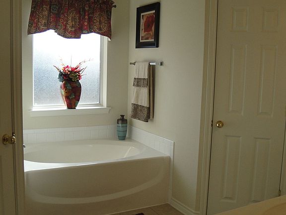 Master Bath featuring garden tub and two walk-in closets