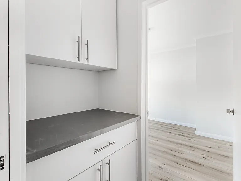 Hallway with Cabinet Space Leading to Bedroom