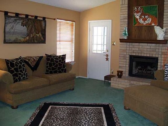 Living area with gas log fireplace.