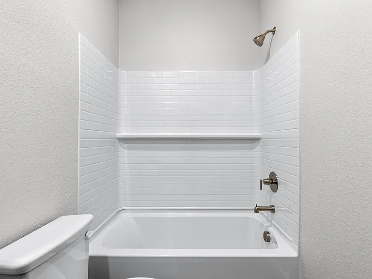 The secondary bathroom has a shower-tub combo.