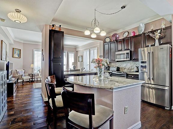 New Cabinetry, beautiful Granite and Stainless appliances reflect from the gleaming Hardwood Floors.