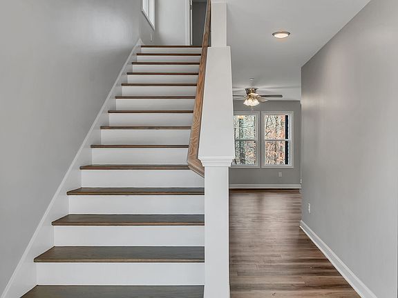Stairs lead upstairs to bedrooms or walk past to the cozy private living room and kitchen area.