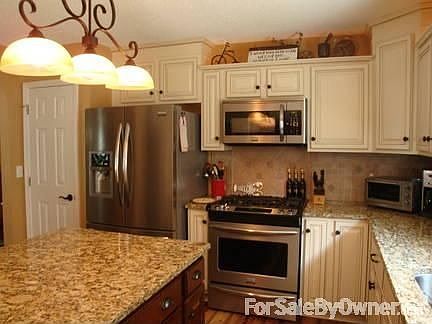 Kitchen
						:
						Island kitchen with granite countertops and stainless appliances