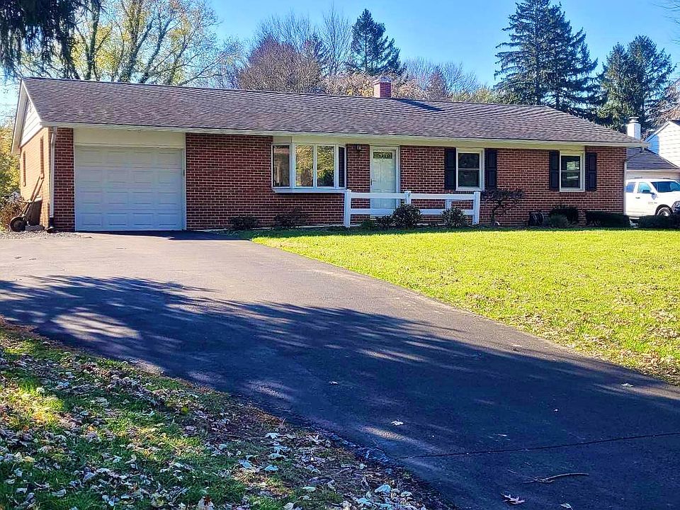 Front of home, single-car garage, with additional parking pad off driveway