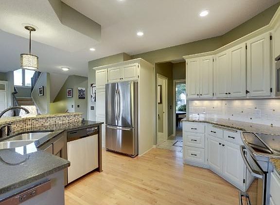 Note the hardwood floors, stainless appliances & well designed flow.