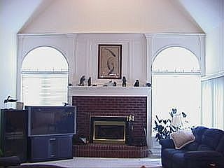 Great room with double palladium windows and raised hearth fireplace