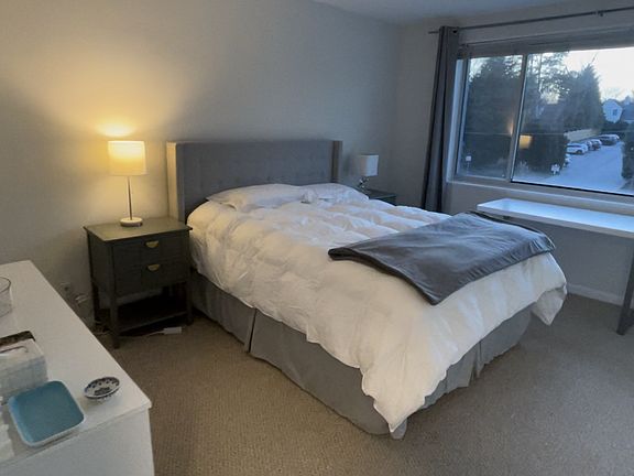 Large bedroom with full size closets lining the entire wall. Looks out onto residential street not Battery Lane. Blackout blinds installed.
