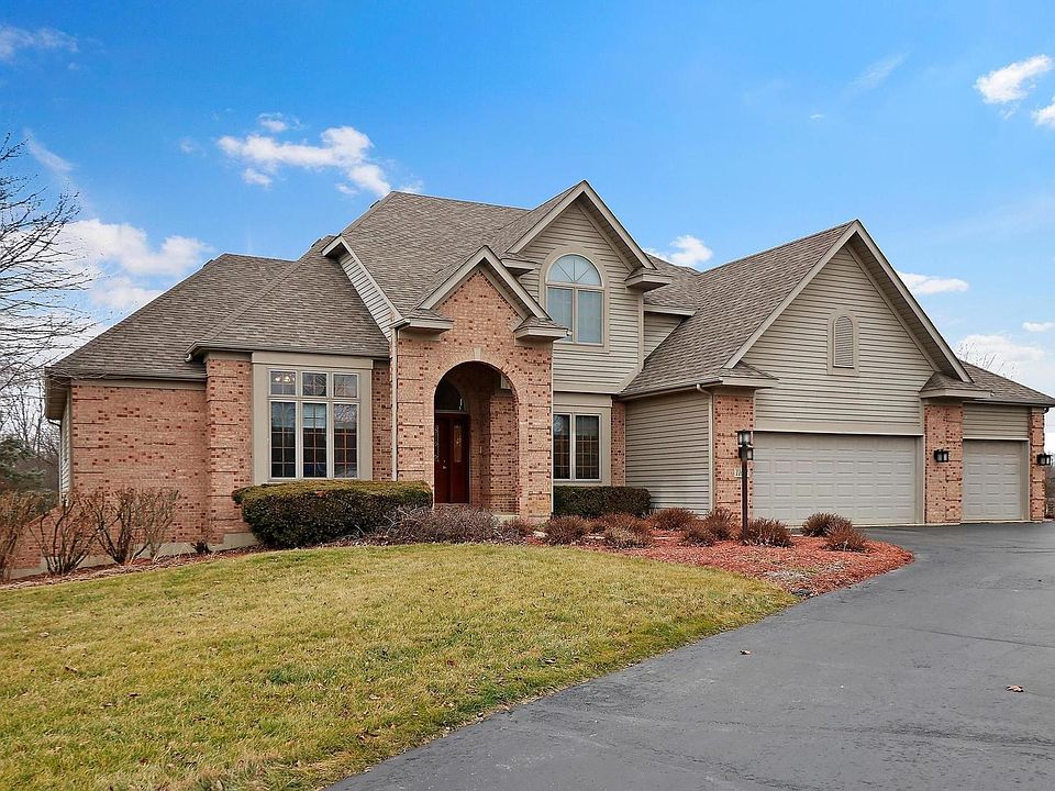 Brick & Cedar home with a circular drive.