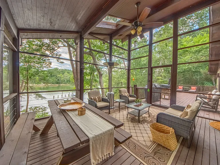 Screened porch overlooking water front.