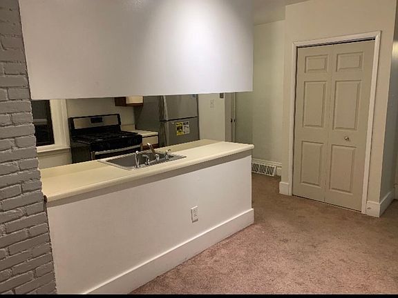 Kitchen, coat closet, hallway to bathroom from entry area