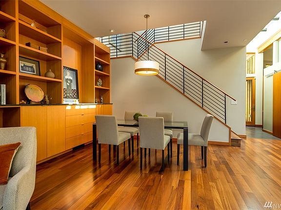 Bright light streams through the main floor and upstairs skylight windows down into the dining and living rooms, adding soft diffused light to the beauty of the Peruvian Olivewood floors and the vertical grain cabinetry.