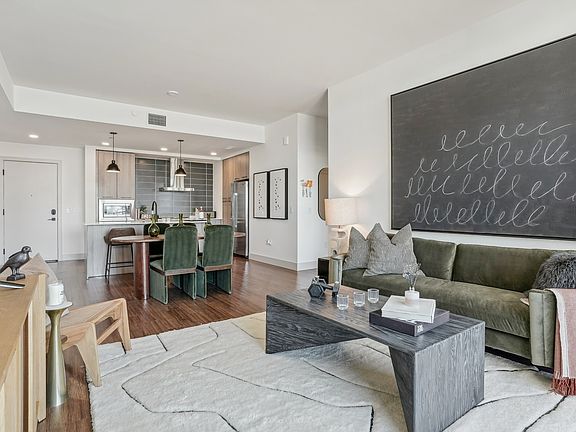 A spacious, stylish living and kitchen space with curated textures and tones.