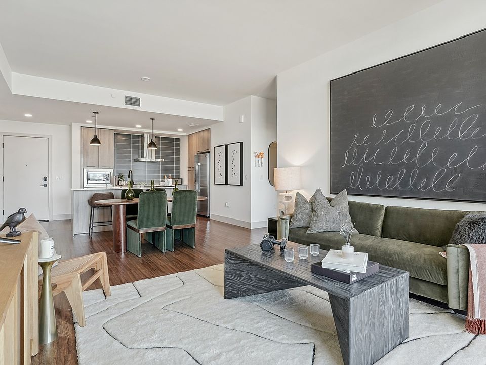 A spacious, stylish living and kitchen space with curated textures and tones.