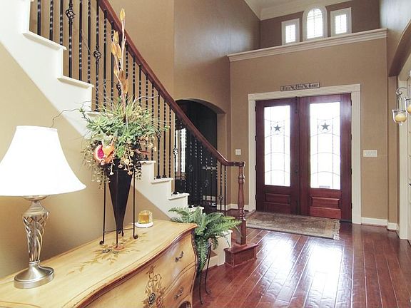 Dramatic Entry with wood flooring, high ceilings