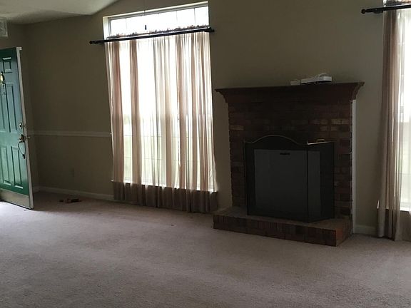 Living room has gas fireplace and lots of light.