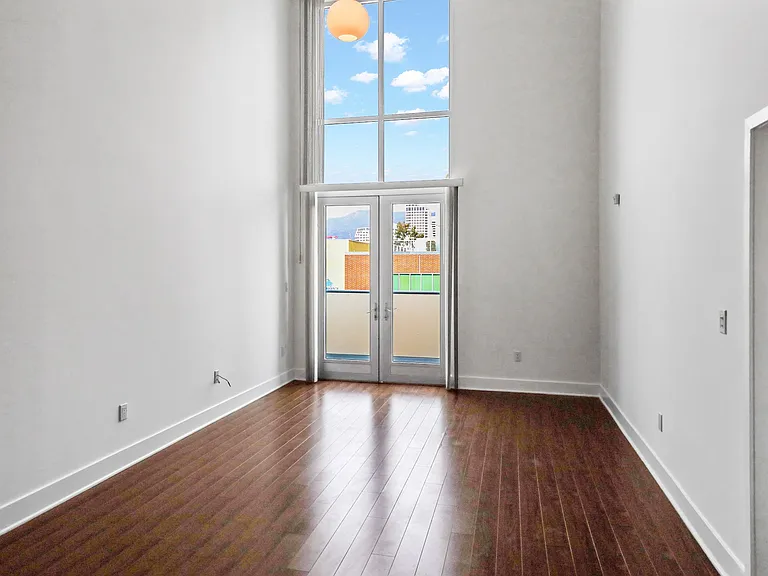 Living Room Space with Vinyl Flooring and Floor to Ceiling Windows