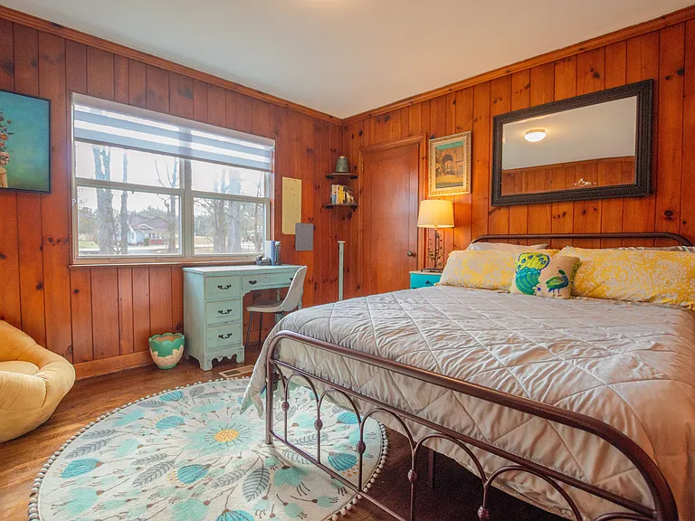 Bedroom #2 with original knotty pine is warm and welcoming!