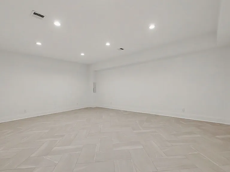 A finished lower level with flexible living space and generous storage, ideal for a media room, gym, or playroom.