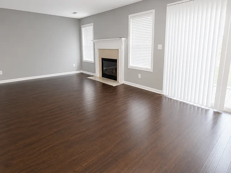 Spacious family room highlighted by a cozy fireplace, large windows, and plenty of room for relaxing or entertaining.