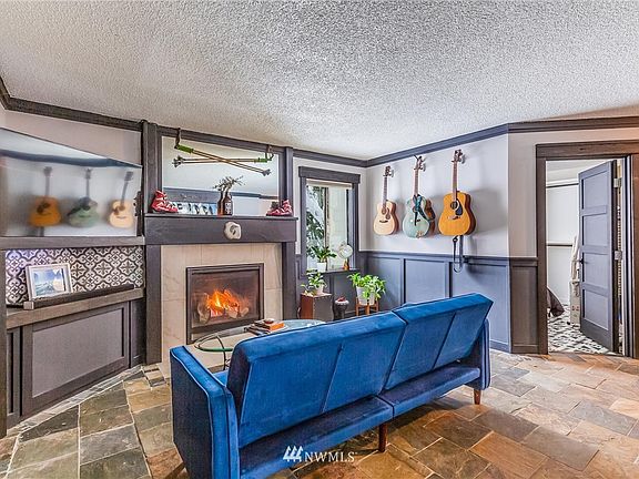 Another shot of the living room. The door leads to the primary bedroom and a deck.