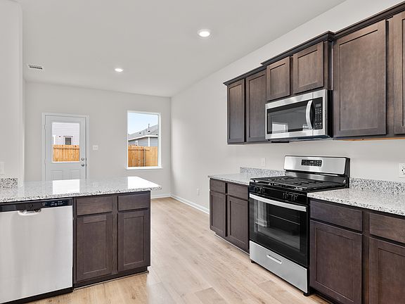 The kitchen has energy-efficient, stainless-steel appliances.