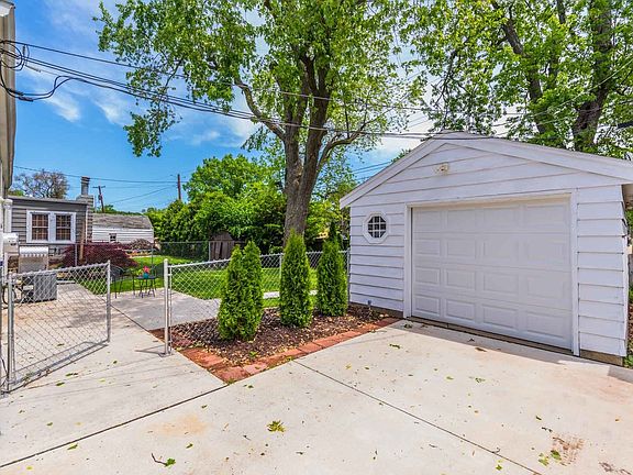 Oversized garage with extra side space, service door, electric opener.