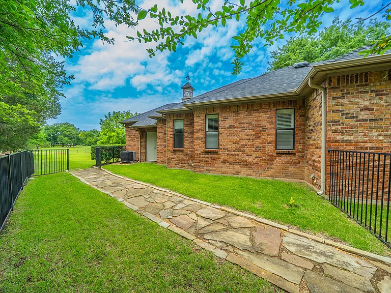 Architectural Charm: Brick Exterior with Winding Concrete Path