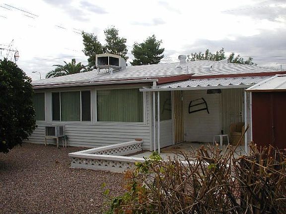 Back of home with patio and "Arizona room"