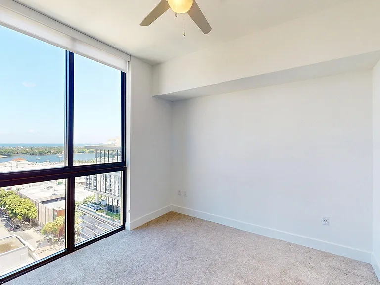 Spacious apartment Bedroom with carpet flooring.