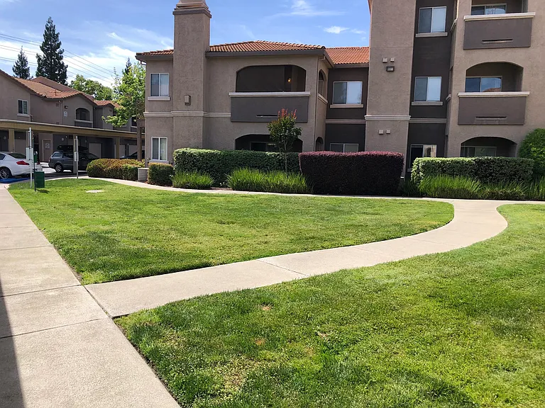 Beautifully landscaped and maintained property grounds with multiple Doggie bag/trash stations located throughout the property.